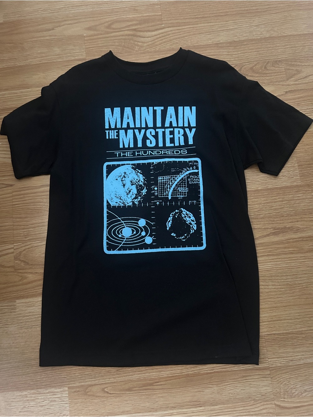 The Hundreds Black T‑Shirt with Light Blue 'Maintain the Mystery' Graphic